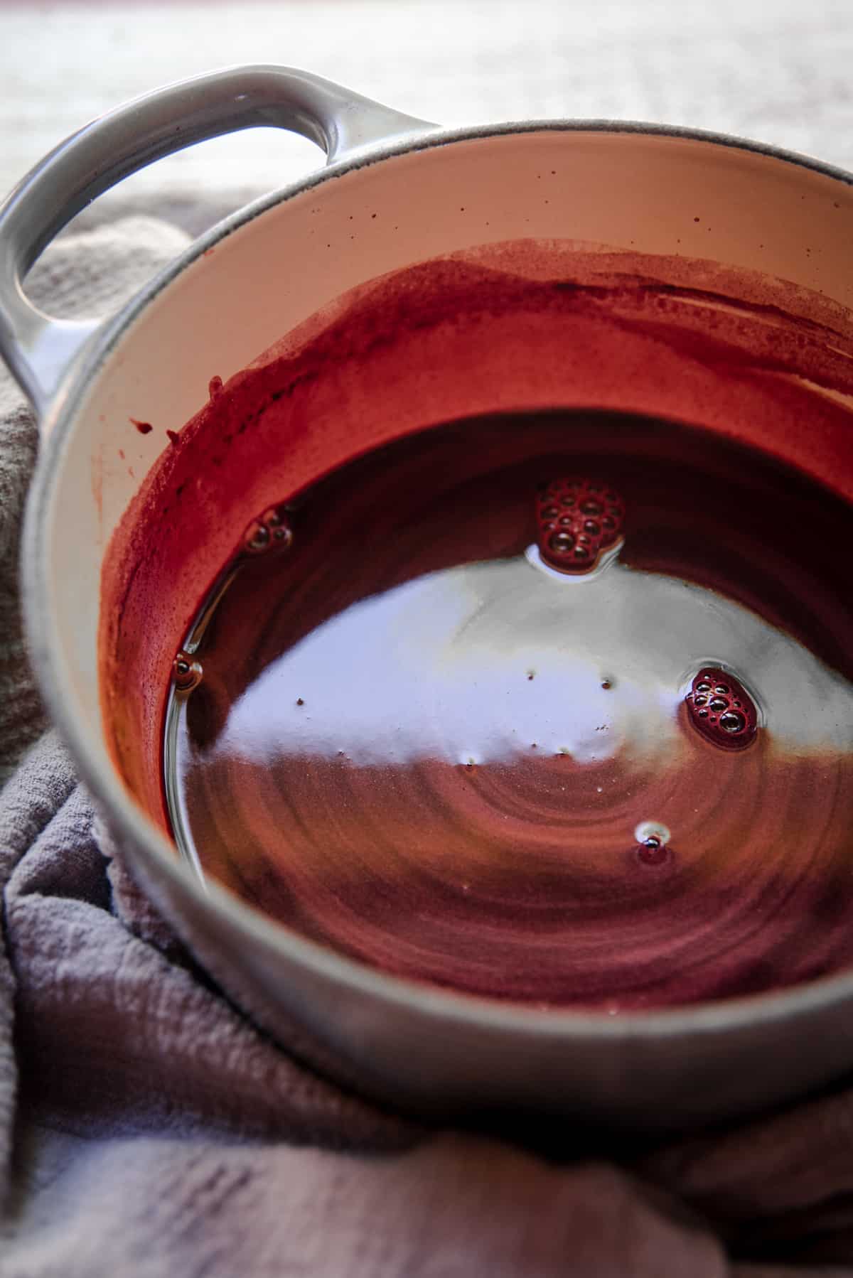 close up of hibiscus syrup in a saucepan