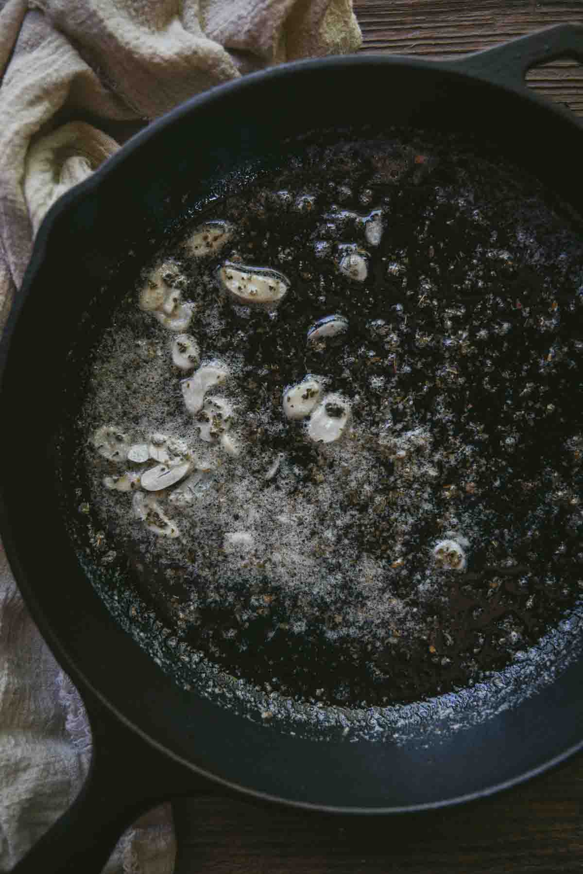 melted butter, garlic and dried herbs in a cast iron skillet