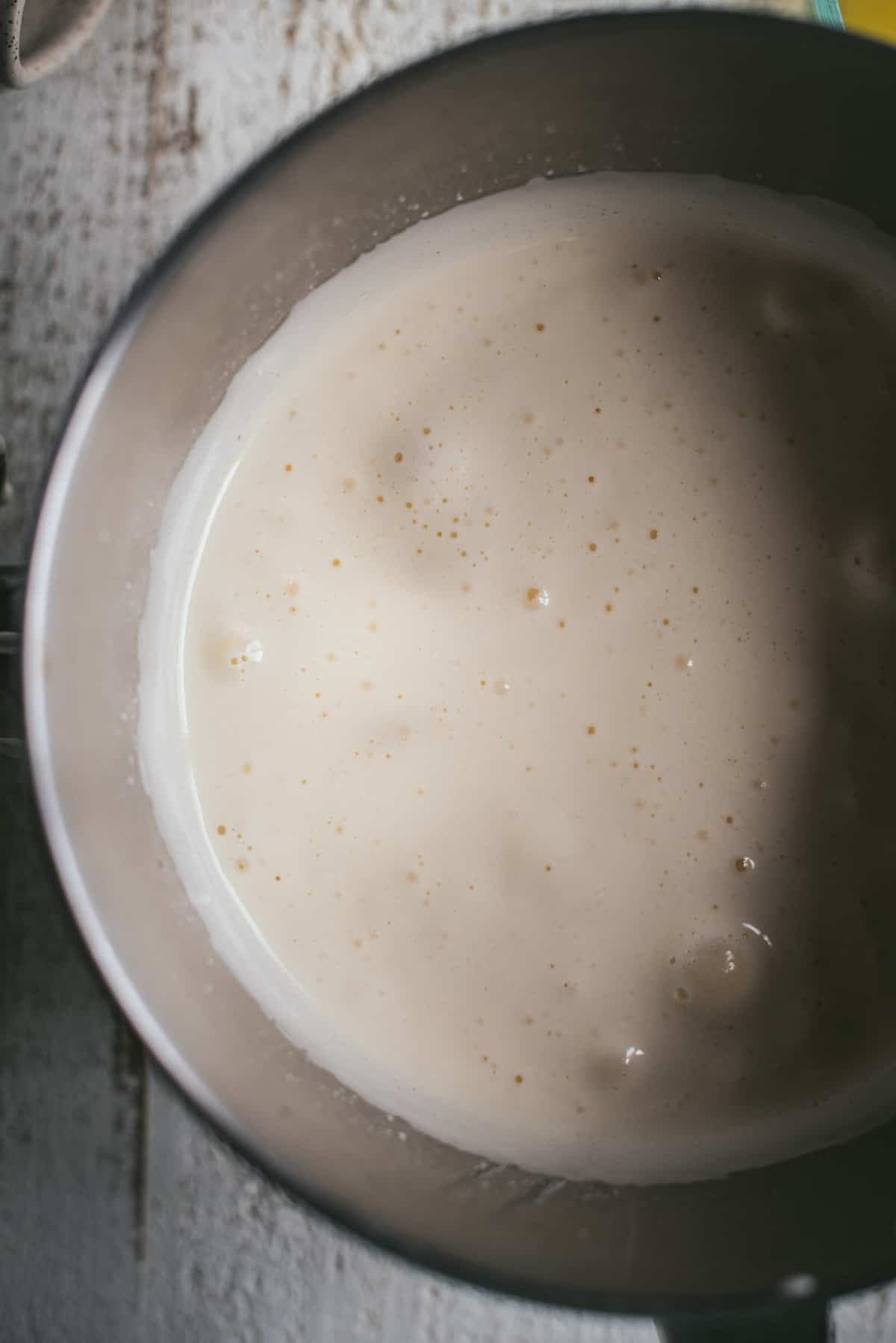 Fluffy beaten eggs and sugar in a mixing bowl