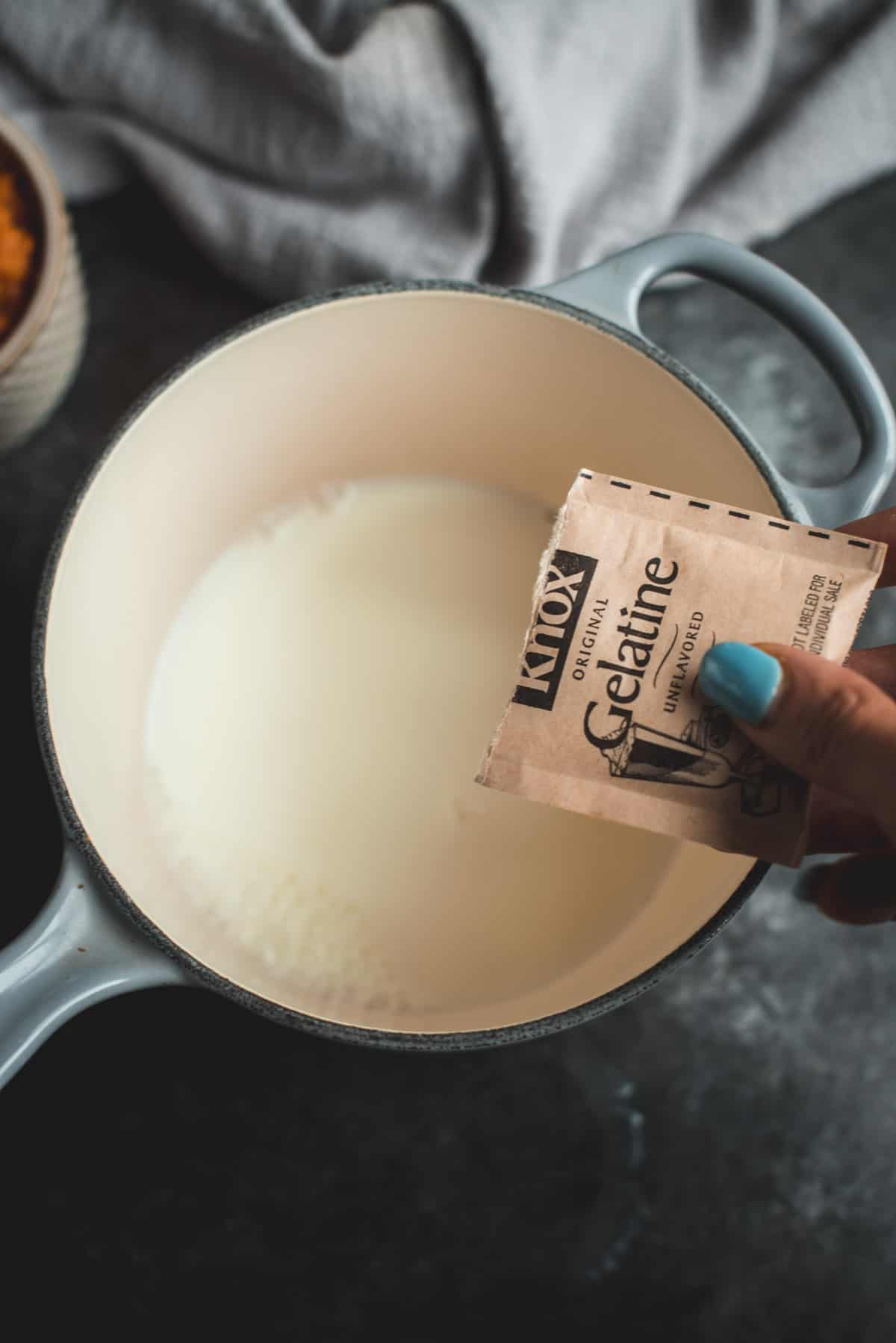 In a  grey heavy bottom saucepan, gelatine is added to milk.