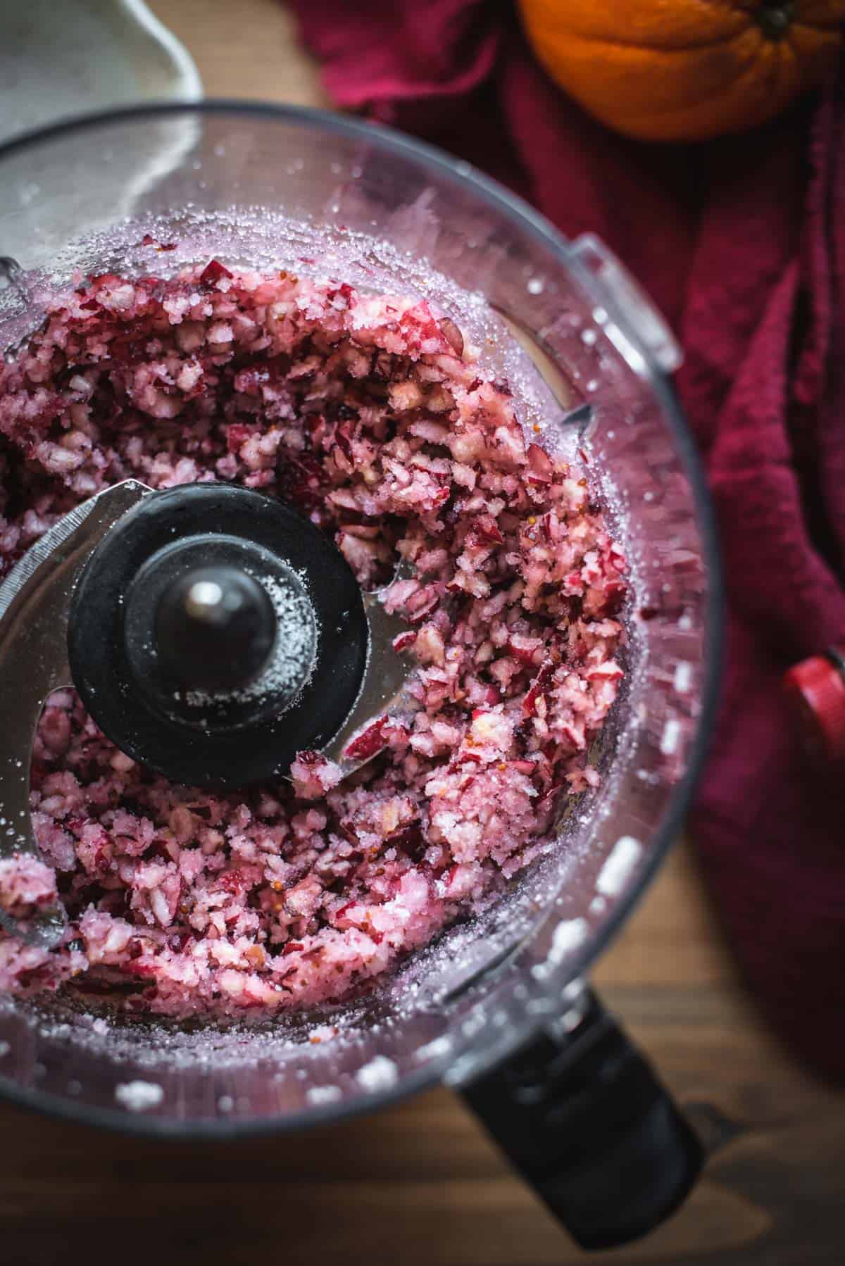 View from above of a blender after it has blitzed the cranberries with sugar.